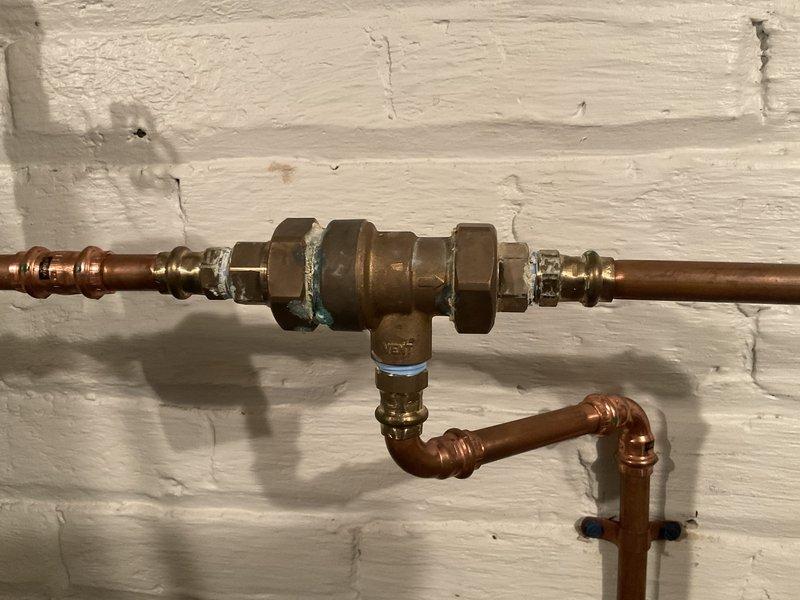 Performed annual maintenance and tune-up on 2-year-old furnace system. Inspected burner assembly for proper ignition and flame pattern, confirming normal operation with consistent blue flame across all four burners. Examined copper gas line connections and valve assembly, noting no leaks or corrosion issues. System functioning correctly with all components in good working condition.