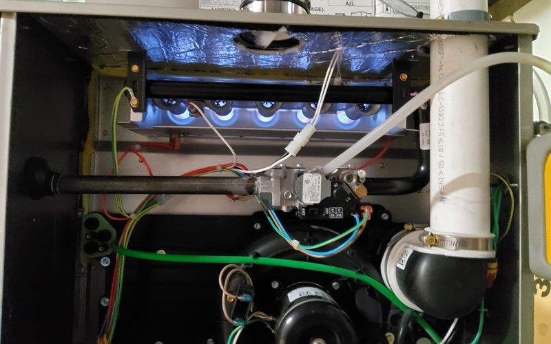 Responded to no heat call for a recently installed system showing flashing yellow indicator light. Diagnosed failed MVP (Modulating Valve Position) on gas valve assembly. Repaired electrical connection to restore proper flame sequence, verified normal blue flame pattern on burner assembly, and confirmed system operation through complete heating cycle.