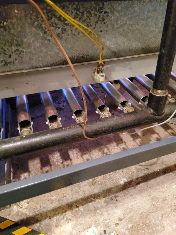Responded to no heat call for natural gas boiler. Inspected burner assembly and found system operational with proper blue flame pattern across all burner tubes. Verified ignition sequence and flame sensor operation. System is now functioning normally with no further issues detected.
