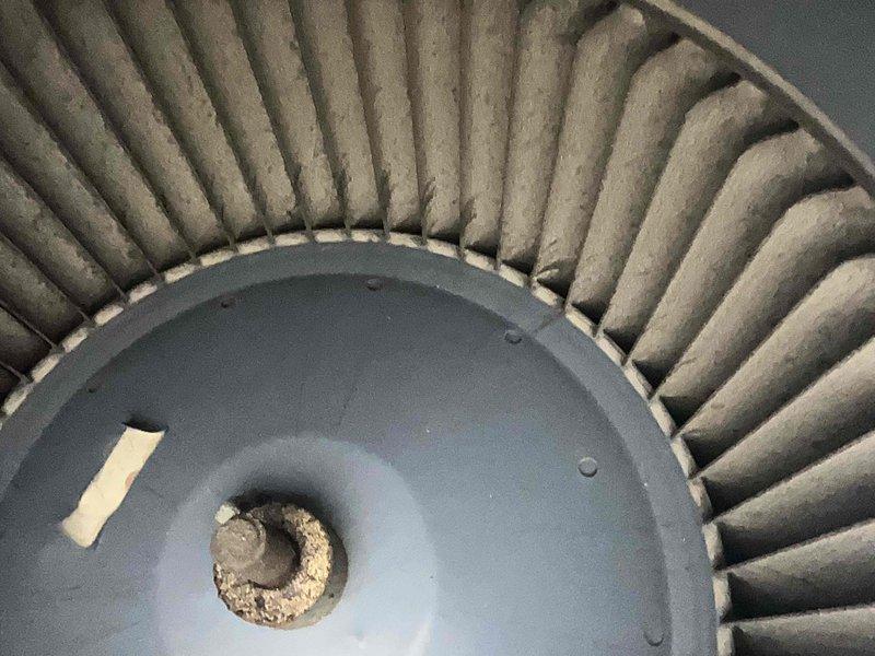 Performed scheduled maintenance on heating system per homeplan agreement. Inspected blower wheel which showed significant dust and debris accumulation requiring cleaning. Also noted American ProLine commercial grade water heater with some corrosion at copper pipe connections and mineral buildup at joints. Vent pipe appears functional with normal aging signs.