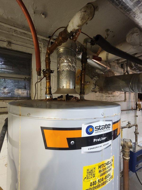 Completed inspection of State ProLine commercial grade water heater in century home. System has proper copper pipe connections with brass fittings and appropriate venting with aluminum-wrapped vent pipe. Water heater appears to be functioning normally with no immediate concerns identified.