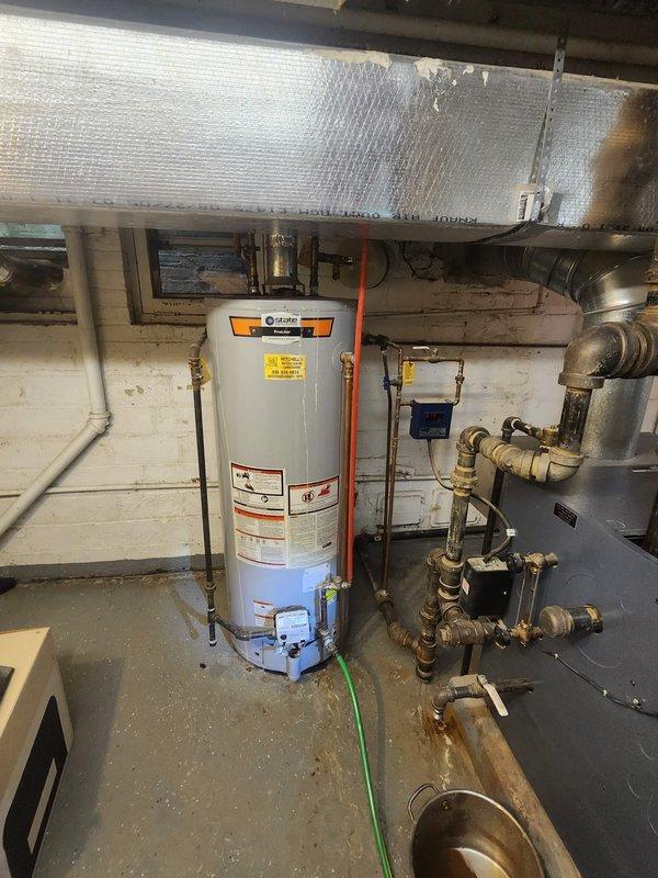 Completed inspection of State ProLine commercial grade water heater in century home. System has proper copper pipe connections with brass fittings and appropriate venting with aluminum-wrapped vent pipe. Water heater appears to be functioning normally with no immediate concerns identified.