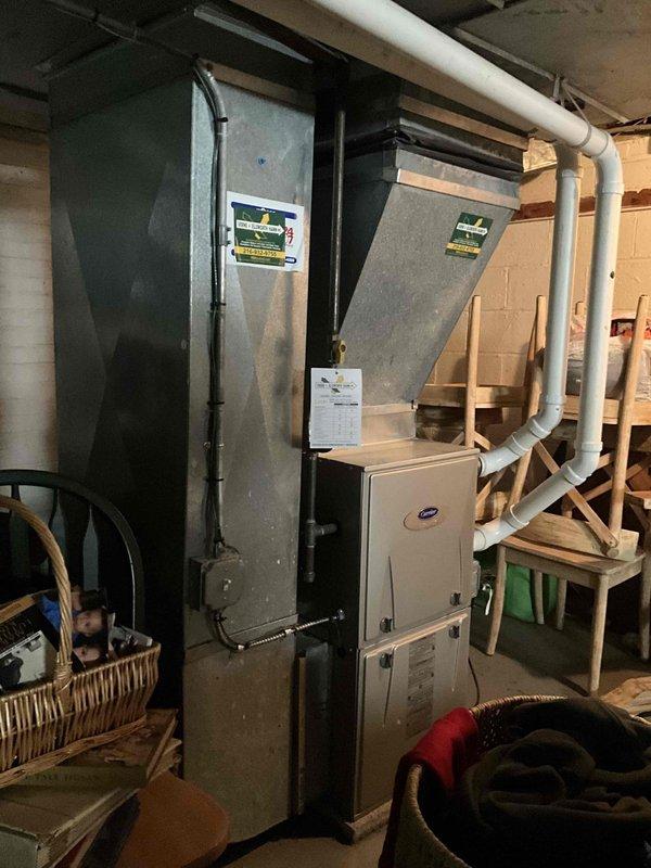 Conducted comprehensive evaluation of existing HVAC system for potential replacement. System located in basement utility area shows significant age deterioration with estimated 2/10 remaining service life. Documented current setup including furnace unit, ductwork configuration, and ventilation components to prepare accurate replacement proposal for client Derek.