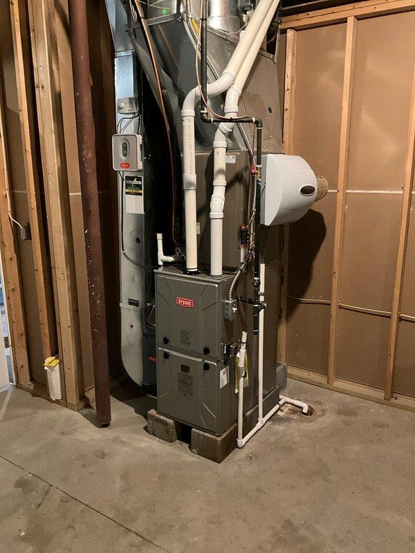 Successfully installed new Bryant furnace on existing 8" blocks for the 2nd floor system, reusing the 2" PVC venting, filter, and existing Honeywell zone damper control system. Added a humidifier to the setup while maintaining compatibility with existing thermostats. All components were properly connected with organized piping and appropriate electrical connections.