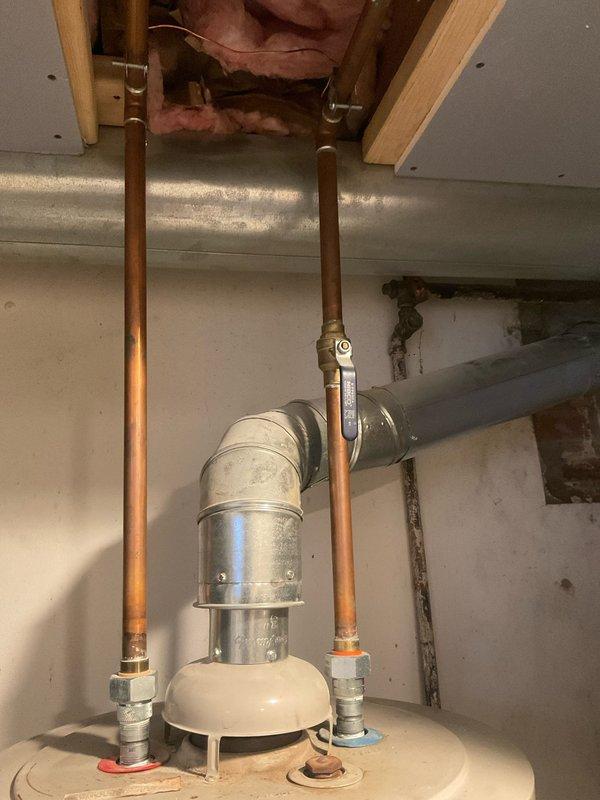 Performed inspection of existing A.O. Smith ProMax water heater installation. System features copper supply lines, metal vent pipe with 90-degree elbow, and standard shut-off valves. Noted proper installation with no visible leaks or deterioration in tank or plumbing components. Provided estimate for new hot water tank replacement as requested by customer.