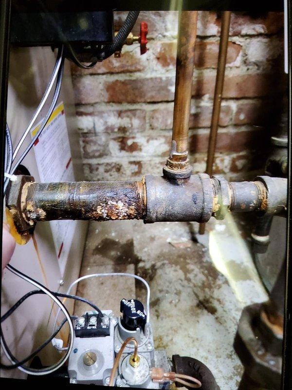 Performed scheduled maintenance tune-up on aging boiler system. Inspected all components including copper and metal piping, valves, and control assembly. Noted significant corrosion and rust on horizontal metal pipe requiring future attention, though system is currently operational. Customer confirmed and was present during service.