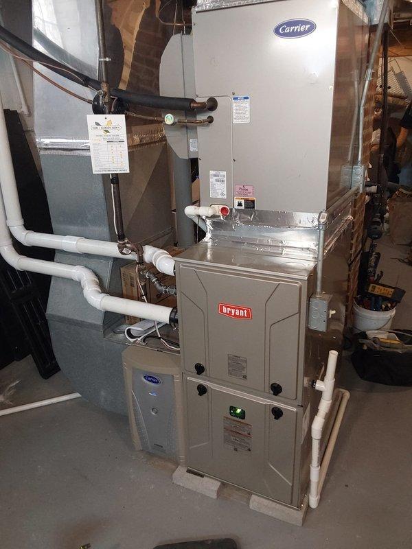 Successfully installed new Bryant furnace and digital programmable thermostat as part of a dual fuel hybrid system. Reconnected to existing 2" PVC venting and preserved the customer's current air cleaner, humidifier, and Carrier heat pump. System is functioning properly with temperature reading 72°F and humidity at 33%.