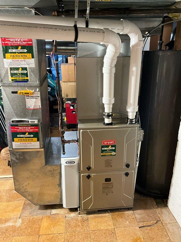 Completed full HVAC system replacement including installation of new Bryant furnace with PVC ventilation system, evaporator coil, air conditioning unit, and smart thermostat (showing 76°F with 31% battery). Additional components installed include model 1210 humidifier, air base, and 4" liner for improved system performance and air quality.