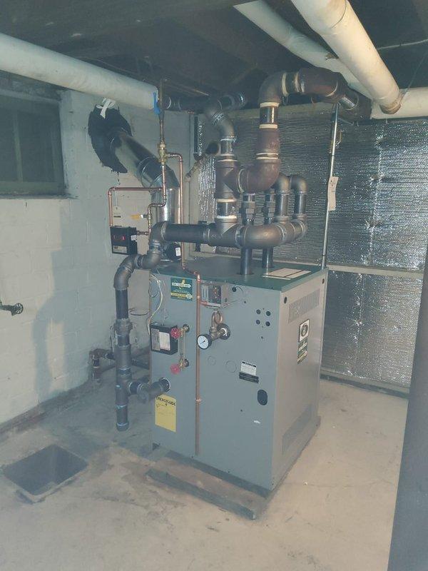 Successfully installed new steam gas boiler with dual 2" risers connecting to existing 3" header as specified in installation manual. Replaced two main steam vents and installed new backflow preventer and automatic water feeder while preserving the existing vaporstat and thermostat. All connections properly secured and system tested for optimal performance.