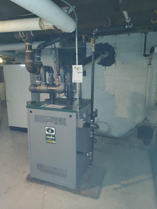 Successfully installed new steam gas boiler with dual 2" risers connecting to existing 3" header as specified in installation manual. Replaced two main steam vents and installed new backflow preventer and automatic water feeder while preserving the existing vaporstat and thermostat. All connections properly secured and system tested for optimal performance.