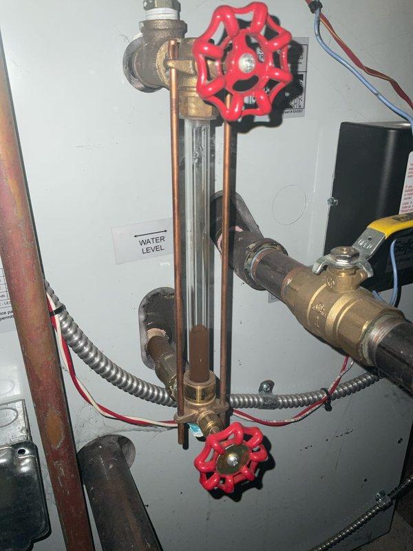 Completed scheduled boiler tune-up service on 7-year-old system. Inspected water level gauge assembly and control wiring connections. System operating within normal parameters; no issues identified during preventative maintenance.
