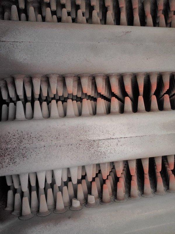 Completed annual inspection on boiler heating system. Inspected heat exchanger fins for dust accumulation and checked burner assembly for proper flame pattern and color. System operating with normal blue flame signature; cleaned minor dust buildup from heat exchanger fins to ensure optimal thermal transfer.