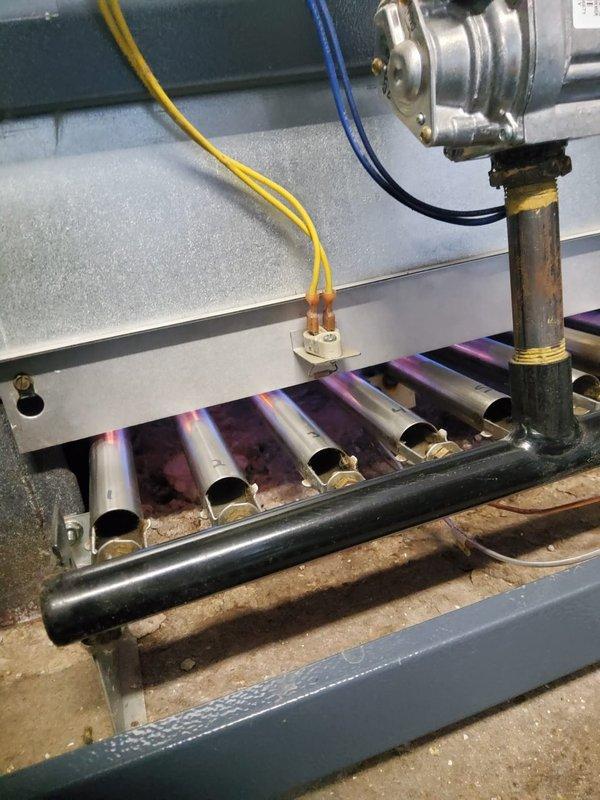 Completed annual inspection on boiler heating system. Inspected heat exchanger fins for dust accumulation and checked burner assembly for proper flame pattern and color. System operating with normal blue flame signature; cleaned minor dust buildup from heat exchanger fins to ensure optimal thermal transfer.