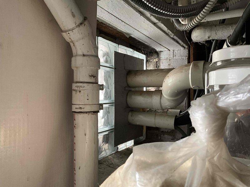 Conducted inspection of mini split system and boiler installation to address improper venting configuration. Identified that boiler exhaust is currently venting directly onto mini split units, causing them to ice over. Documented existing utility infrastructure in basement mechanical area to prepare comprehensive estimate for proper ventilation system modification.