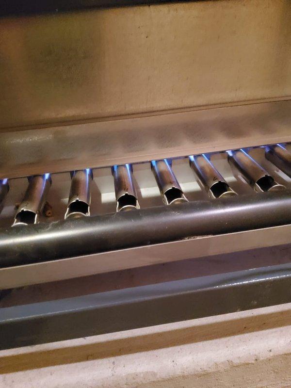 Performed routine maintenance on 12-year-old boiler system. Inspected burner assembly and confirmed proper flame pattern with consistent blue flames across all ports. Examined heat exchanger which showed normal wear with some surface oxidation and minor mineral deposits, but remains functionally sound without any safety concerns.