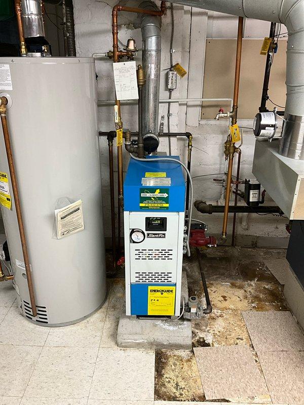 Performed comprehensive boiler inspection on Weil-McLain unit. Evaluated overall system condition including pressure readings, exhaust ventilation, and connected piping network. Identified improper exhaust configuration requiring correction to meet code requirements.
