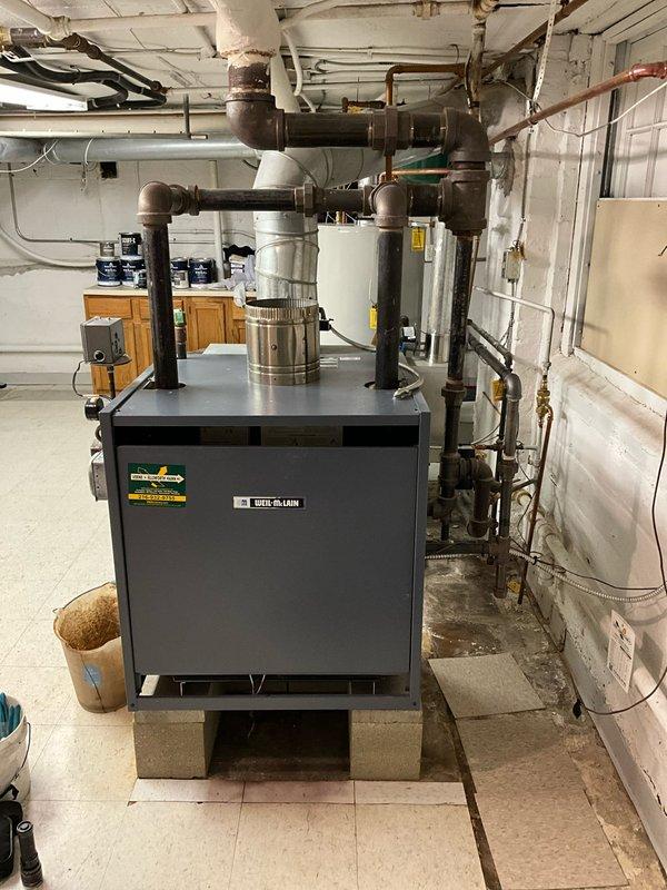 Performed comprehensive boiler inspection on Weil-McLain unit. Evaluated overall system condition including pressure readings, exhaust ventilation, and connected piping network. Identified improper exhaust configuration requiring correction to meet code requirements.