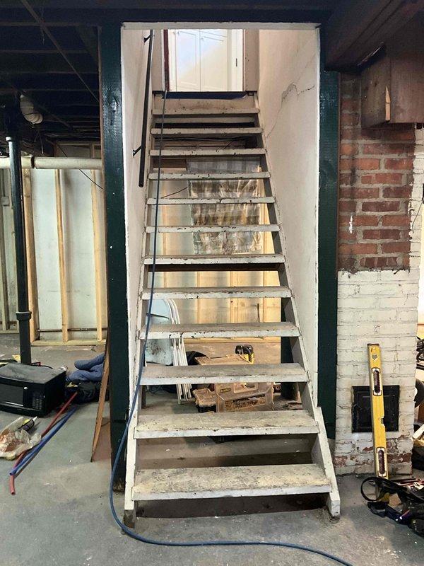 Performed routine maintenance on dual boiler system including thorough brushing to remove soot accumulation and operational cycling test. Inspected wet burner as reported and documented system condition through photographs of the basement mechanical room showing water heater, furnace, and associated ductwork/piping configuration.