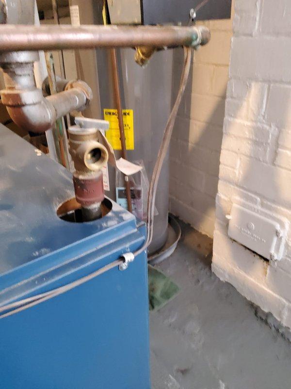 Installed pressure relief valve on existing boiler system for new homeowner. Inspected radiator connections and verified proper operation of the heating system after installation. Equipment appears to be functioning normally despite unknown age.