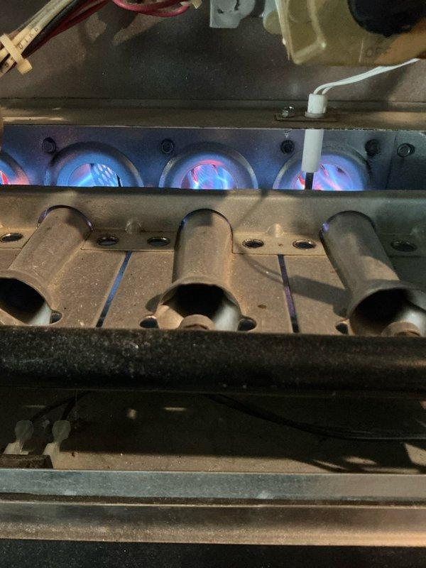 Performed 12-point tune-up on 21-year-old furnace. Inspected burner assembly and verified proper flame pattern with strong blue flames indicating good combustion. Combustion analysis readings showed normal operation with O2 at 7.0%, CO at 17 PPM, CO2 at 7.9%, and stack temperature at 407.2°F, confirming efficient operation within manufacturer specifications.