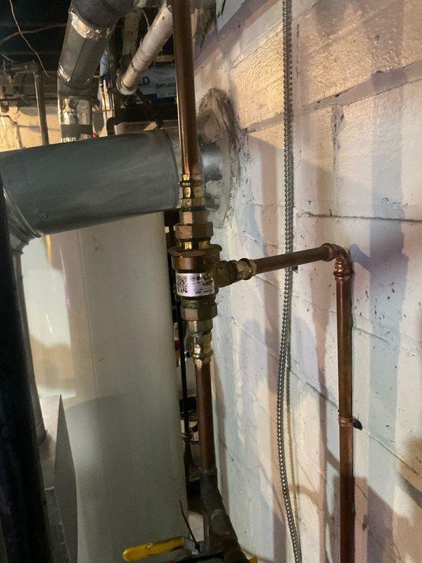 Completed routine tune-up service on 5-year-old boiler system. Inspected pressure gauge, valve assembly, and copper piping connections for proper operation. Verified system pressure readings and checked all connections for signs of leaks or moisture issues, particularly around the wall penetrations where previous staining was observed.