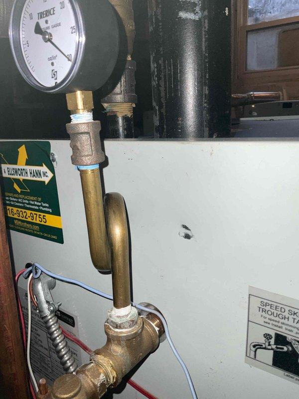 Completed routine tune-up service on 5-year-old boiler system. Inspected pressure gauge, valve assembly, and copper piping connections for proper operation. Verified system pressure readings and checked all connections for signs of leaks or moisture issues, particularly around the wall penetrations where previous staining was observed.