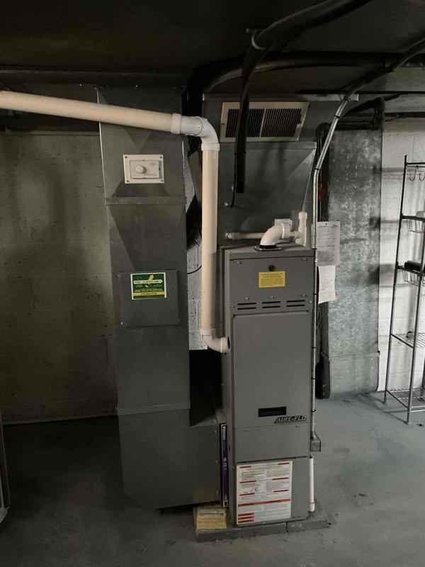 Conducted comprehensive inspection of aging HVAC system in basement utility room, including Amana furnace unit and connected air handler. Documented existing equipment condition, ductwork configuration, and ventilation components to prepare replacement estimate. Evaluation focused on galvanized metal ductwork connections, PVC exhaust piping, and overall system integration for proper replacement specification.
