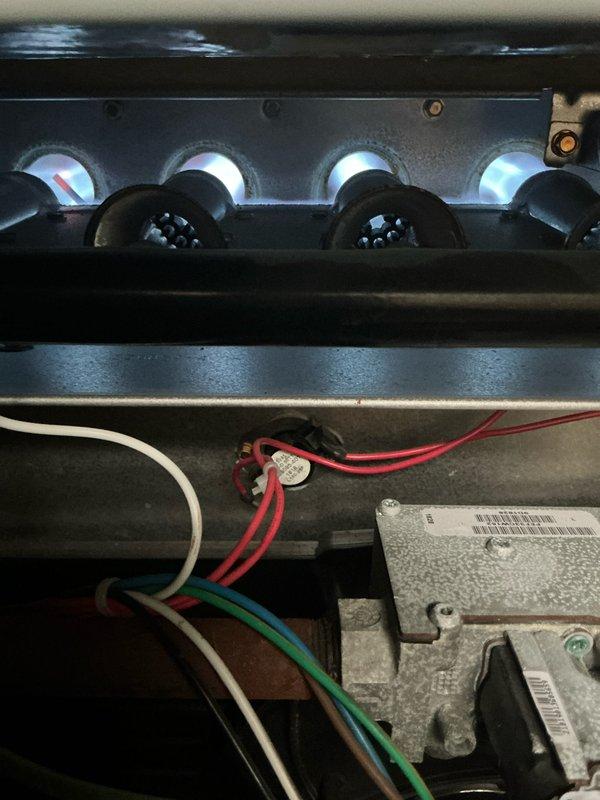 Performed routine maintenance on two heating systems, inspecting burner assemblies and flame patterns which showed proper blue-white ignition. Checked all electrical connections including control module wiring harnesses, ensuring secure contacts and proper functionality of all components.