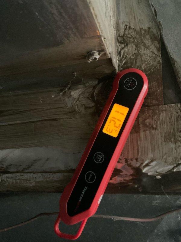 Performed scheduled heating system tune-up, including moisture level assessment of nearby structural wood elements (25.0% reading detected) and system pressure testing with digital manometer (1.53 reading confirmed). Documented areas of concern with photographic evidence, particularly focusing on deteriorated wooden components showing signs of water damage and splitting.