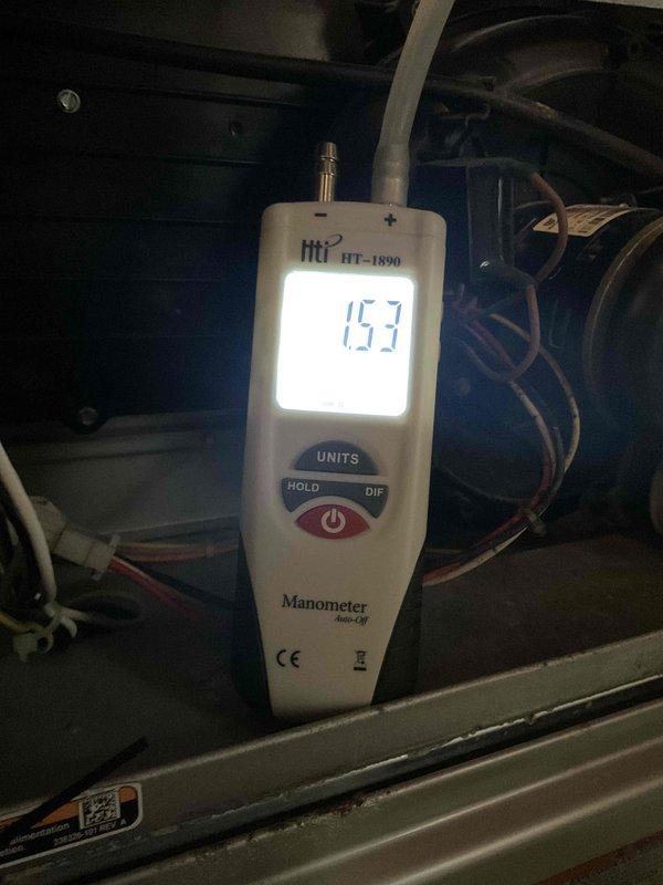 Performed scheduled heating system tune-up, including moisture level assessment of nearby structural wood elements (25.0% reading detected) and system pressure testing with digital manometer (1.53 reading confirmed). Documented areas of concern with photographic evidence, particularly focusing on deteriorated wooden components showing signs of water damage and splitting.