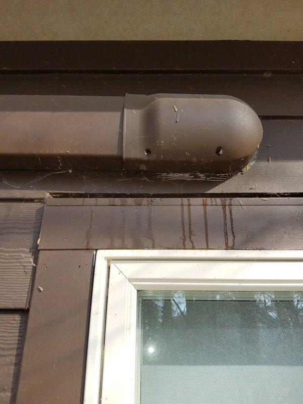Inspected mini split system exhibiting refrigerant leak evidenced by water damage and brown streaking on both exterior siding and interior wall surface. Identified leak source at the line set connection points near window installation where significant staining patterns were observed. Recommended complete line set replacement and system recharge to resolve ongoing refrigerant loss.
