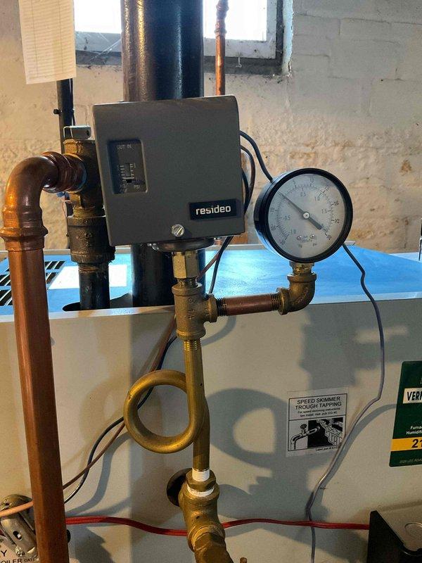 Performed annual boiler tune-up service on a steam gas boiler system with Resideo controls. Inspected all components including pressure gauge, copper/brass piping network, and speed skimmer. System is functioning properly with no operational issues detected.