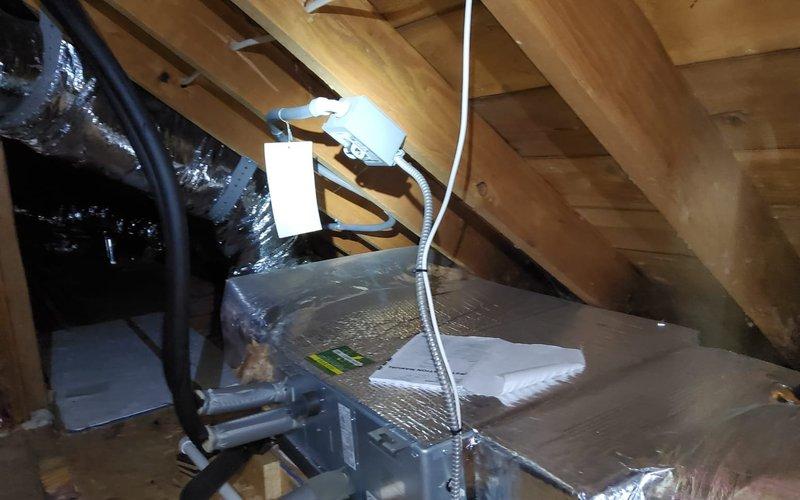 Responded to service call for non-operational mini split system. Performed diagnostic inspection of indoor air handler located in attic space, which was properly insulated with reflective material. Examined exterior condenser unit and verified all line connections were secure. System is now functioning within normal parameters.