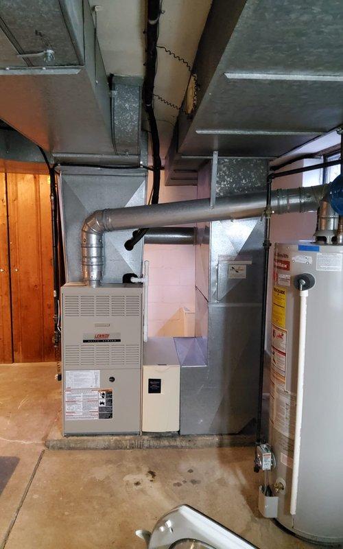 Performed maintenance tune-up on 22-year-old gas furnace for new homeowner. Inspected blower wheel assembly and found it in working condition. Evaluated ductwork throughout the basement, noting proper connections to the Lennox furnace system, and verified all components were functioning correctly.