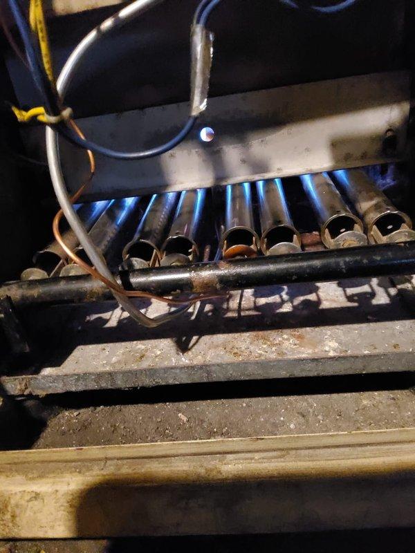 Performed diagnostic service on 10-year-old residential boiler reported as non-operational. Inspection revealed dirty burner tubes causing irregular flame pattern and heat exchanger performance issues. Cleaned burner assembly, verified proper ignition sequence, and confirmed normal operation with consistent blue flame across all ports. Unit is now functioning within normal parameters.