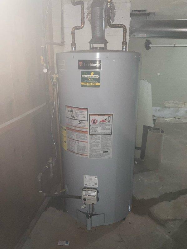 Replaced failing water heater with new Lochinvar unit in 50-year-old residence. Installed new copper supply lines, properly connected flue pipe to existing wall penetration, and verified all connections for leaks. System is now operational with proper venting and compliant installation.