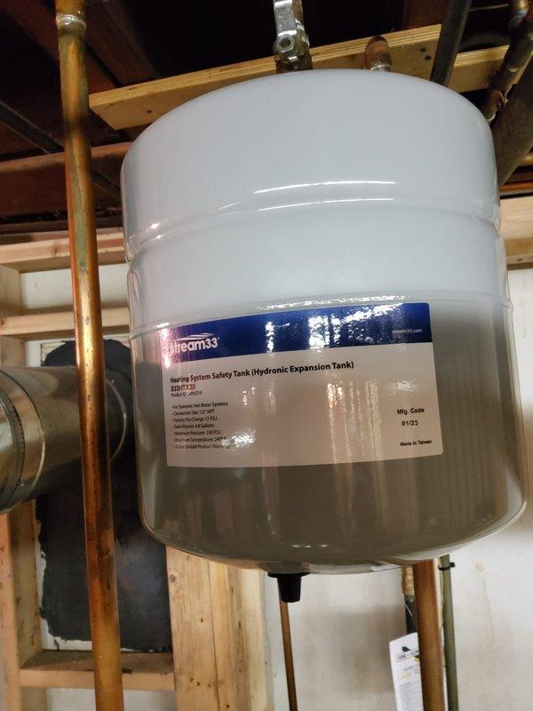 Completed installation of dual boiler system, replacing existing units with new steam boiler for main house (including new backflow preventer and auto feeder) and new hot water boiler with thermostat, backflow/PRV combo, pump and expansion tank. Consolidated ventilation system by replacing flue pipe setup completely, connecting both boilers and hot water tank into a single common vent with appropriate tees, resulting in one larger vent pipe entering the chimney rather than the previous three-pipe configuration.