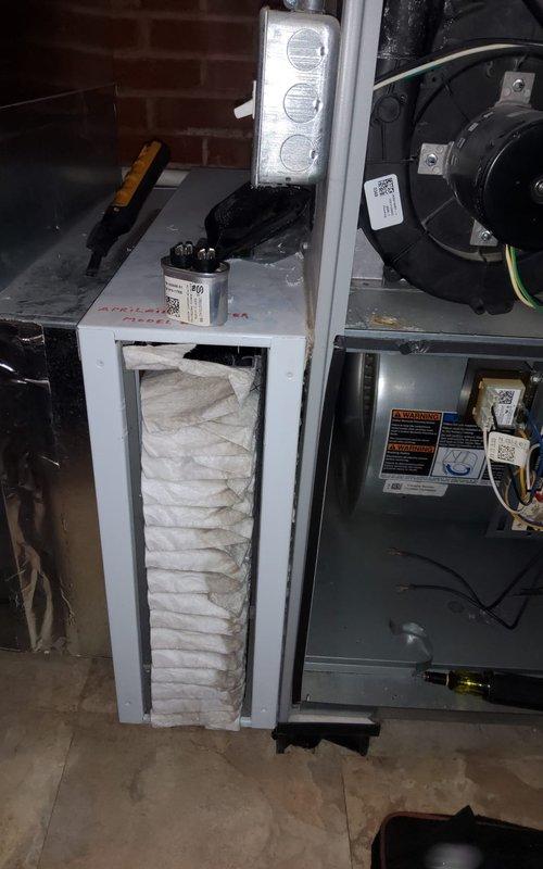Performed standard furnace tune-up on residential system located in basement. Inspected and replaced dirty air filter. Addressed squeaking noise from furnace by lubricating blower motor bearings and checking belt tension. System now operating within normal parameters with noise issue resolved.