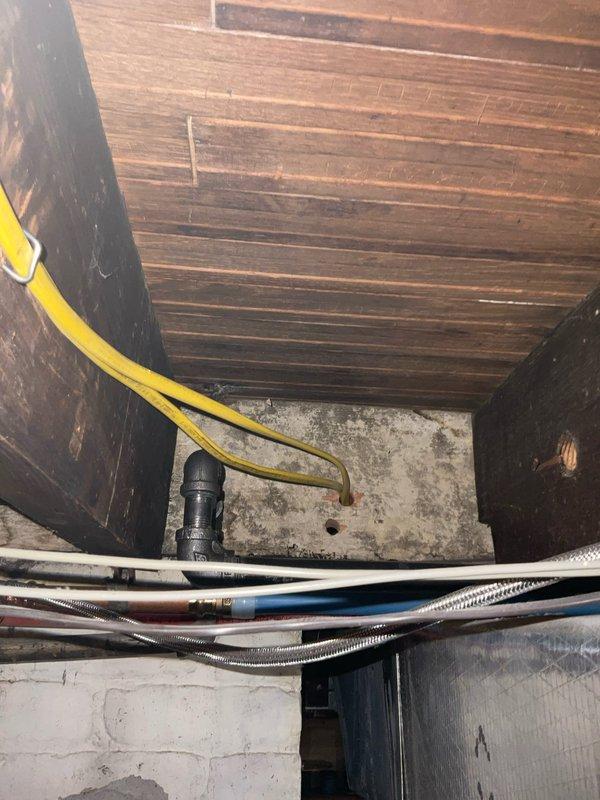 Completed relocation of gas and water supply lines in kitchen area to accommodate customer's remodeling project involving refrigerator and stove repositioning. Accessed utility space to properly route yellow gas line and metal water pipes through the crawlspace. Performed pressure test on completed gas line installation to verify system integrity and ensure no leaks were present.