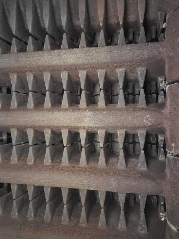 Performed scheduled heating tune-up on residential furnace system. Inspected burner assembly operation, confirming proper flame characteristics with consistent blue flames across all tubes. Noted dust accumulation on heat exchanger fins requiring cleaning to optimize system efficiency and heating performance.
