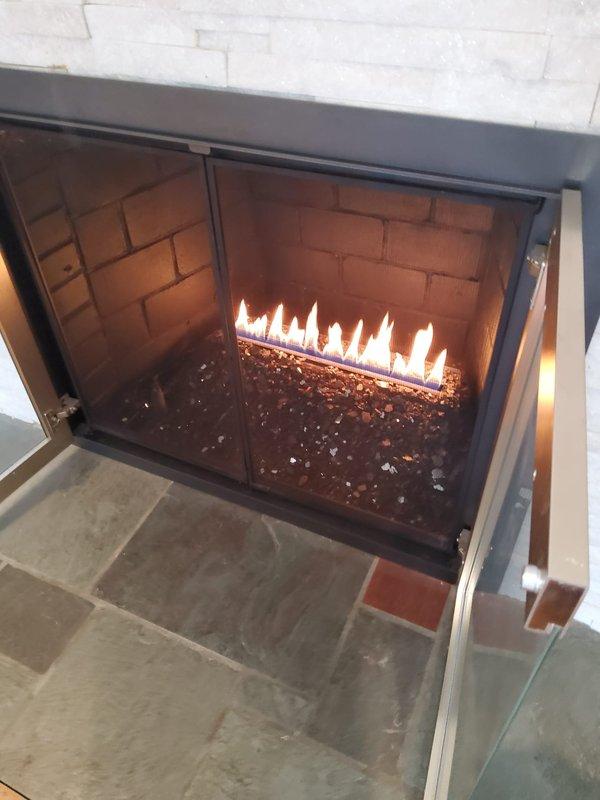 Responded to service call for gas fireplace not receiving gas. Performed pressure test on previously installed gas line to verify integrity. Restored gas flow to fireplace and confirmed proper operation with visible flame pattern across decorative glass media. Fireplace is now functioning correctly with no leaks detected in the supply line.