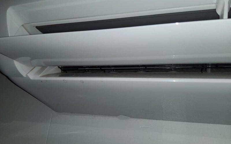 Inspected mini-split system with reported leak; confirmed refrigerant leak along wall with visible condensation damage. Accessed internal components of wall-mounted indoor unit for diagnostic evaluation; system requires refrigerant recharge and leak repair to restore proper operation.