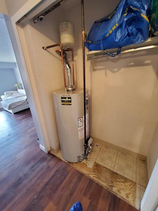 Successfully installed an A.O. Smith ProMax water heater in utility closet, replacing previous unit that had caused significant water damage to surrounding flooring. Connected all copper piping and installed expansion tank above unit, then cycle tested system to confirm proper operation with no leaks.