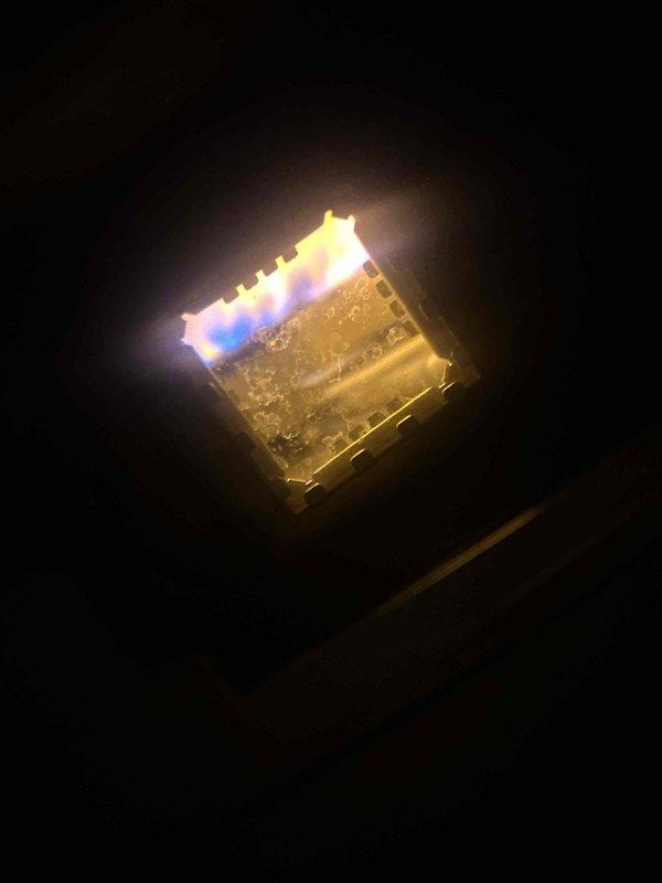 Performed diagnostic inspection on gas-fired tanked water heater in century home. Examined burner assembly, confirming proper flame pattern and combustion (blue flames visible). System functioning normally with no operational issues detected; no repairs required at this time.