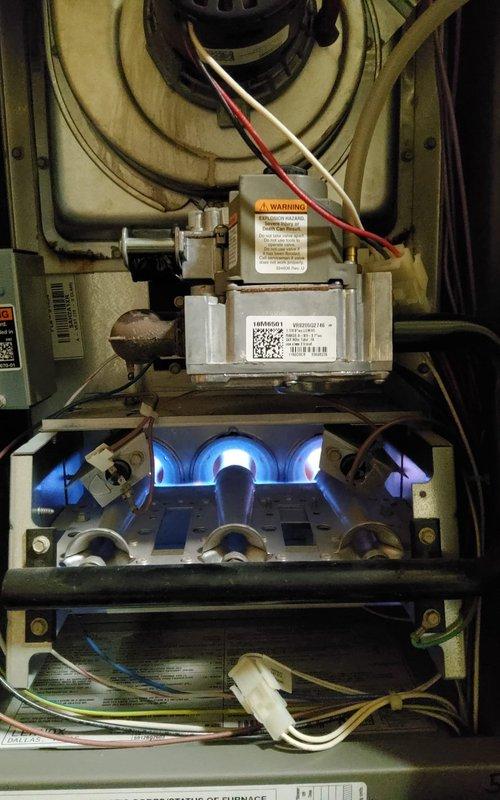 Performed standard maintenance on 13-year-old MVP gas furnace. Inspected gas valve assembly, verified proper flame characteristics with healthy blue flames indicating good combustion, and ensured all wiring connections were secure and properly functioning. System is operating normally with no issues detected.