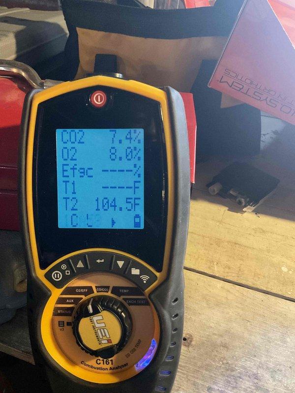 Performed scheduled heating system maintenance. Conducted combustion analysis with UEi C161 analyzer showing normal CO2 (7.4%) and O2 (8.0%) levels at 104.5°F. Temperature probe readings (57.6°) confirmed system operating within parameters.