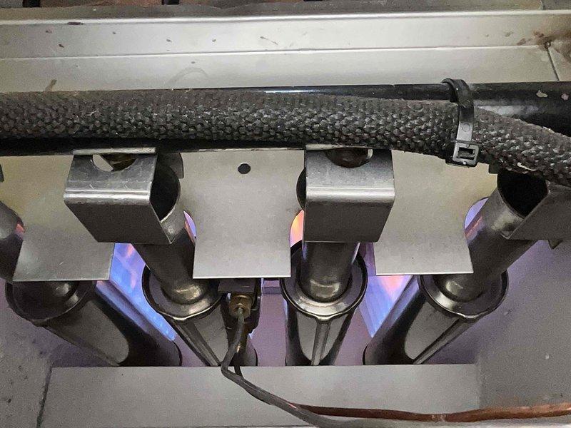 Performed scheduled maintenance inspection on boiler system. Examined heat exchanger components for dust accumulation and conducted visual inspection of gas burner assembly. Verified proper flame characteristics and combustion operation with all four burners functioning normally.