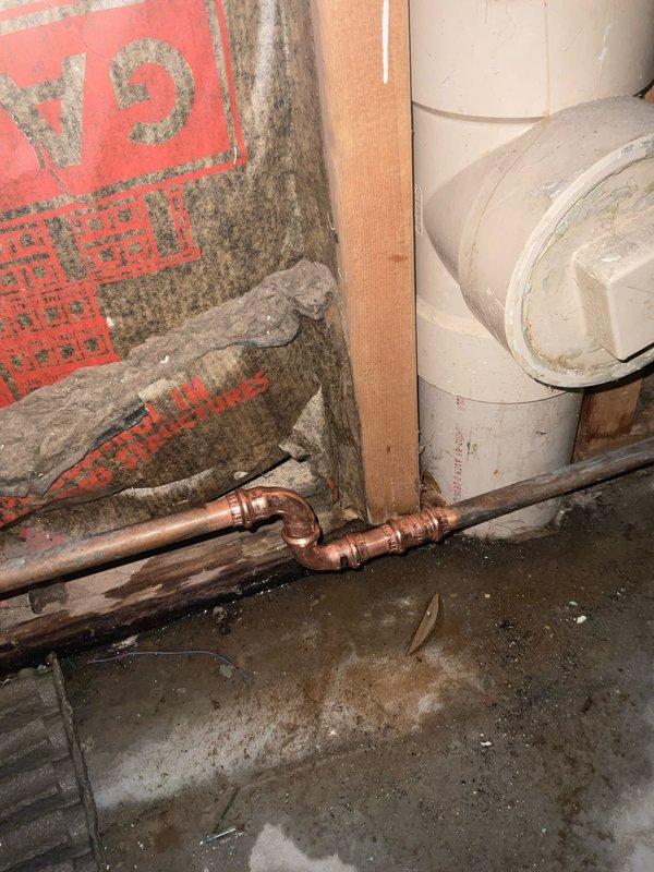 Responded to main water line leak emergency requiring city water shut-off. Installed new copper pipe fittings at the source of the leak, replacing damaged section with proper elbow joint and securing to framing with pipe support brackets. Confirmed repair was successful with no moisture ingress after service completion.