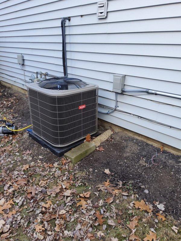 Completed full HVAC system replacement including Bryant condensing unit and new furnace with upgraded venting system. Installed dual 2" PVC flue pipes through garage wall, eliminating existing chimney PVC flue path. Additional work included reusing existing lineset after flushing, replacing return drop, installing Aprilaire filter and Ecobee thermostat, and replacing condensate pump with new tubing.