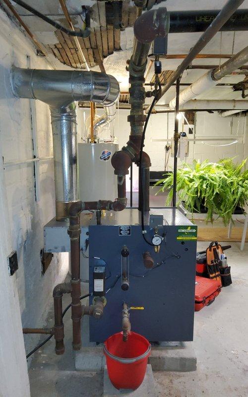 Completed annual inspection on residential steam boiler system. Examined burner assembly with blue flame operation, checked all copper piping connections, and ensured proper pressure readings. Customer renewed maintenance plan with payment collected onsite.